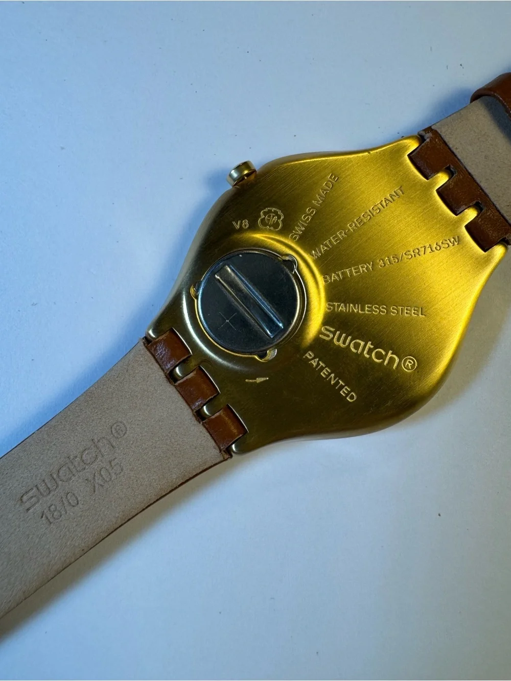 Swatch Skinsand SYXG104 gold-tone and leather analog watch